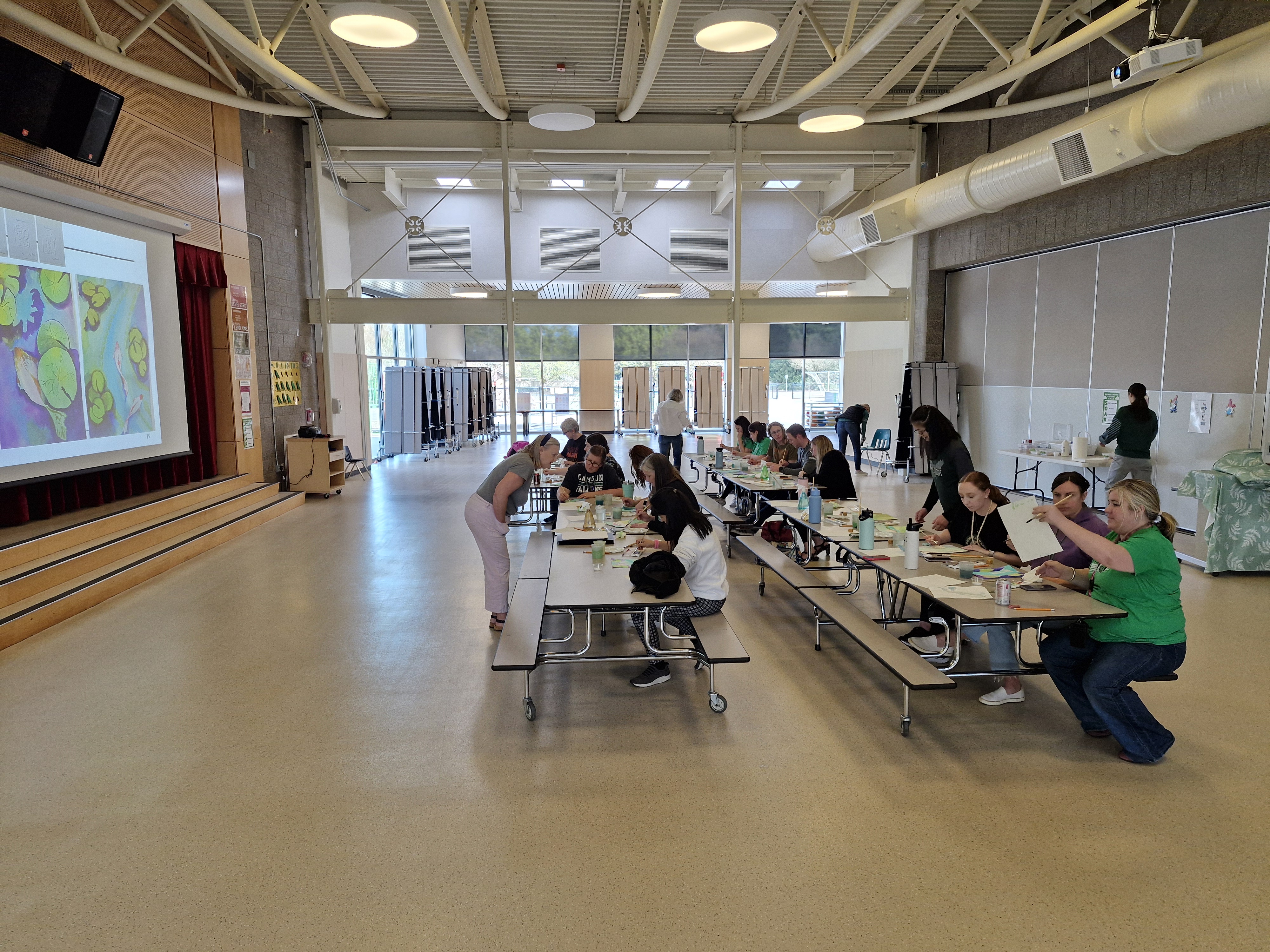 Group of adults painting together at a community workshop event