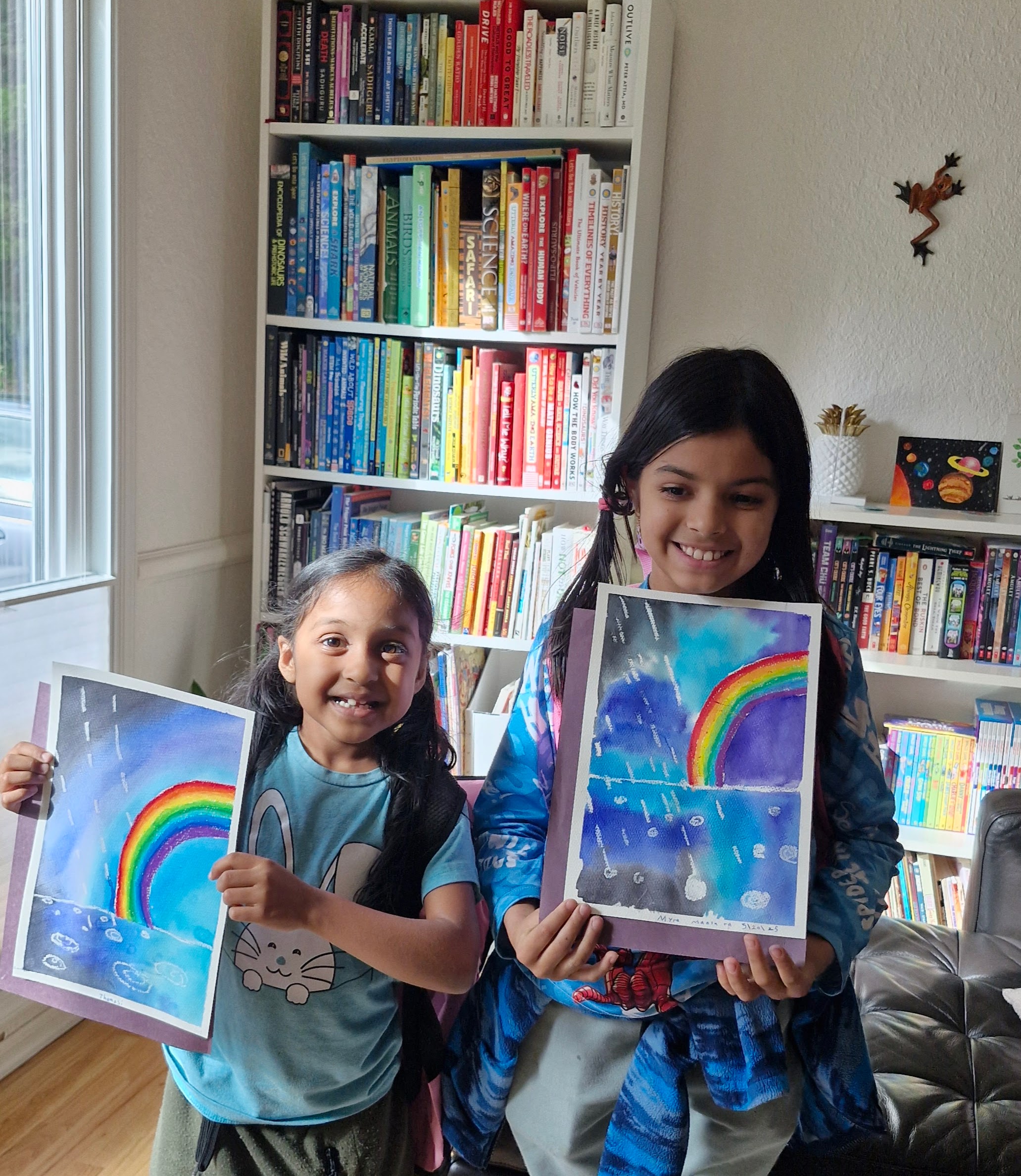 Students proudly displaying their watercolor artwork